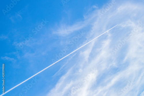 The contrails or the condensation trails in the blue sky background