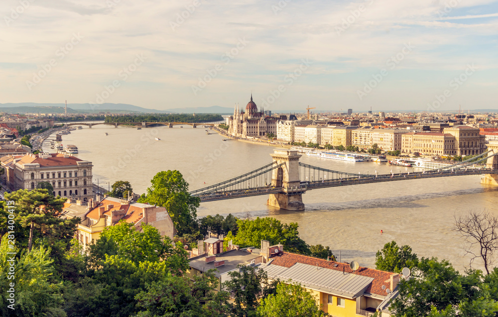 Danube river in Budapest with the historic building in the background in a sunny day