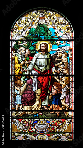 Jesus blesses mothers with children, stained glass window in the Saint John the Baptist church in Zagreb, Croatia