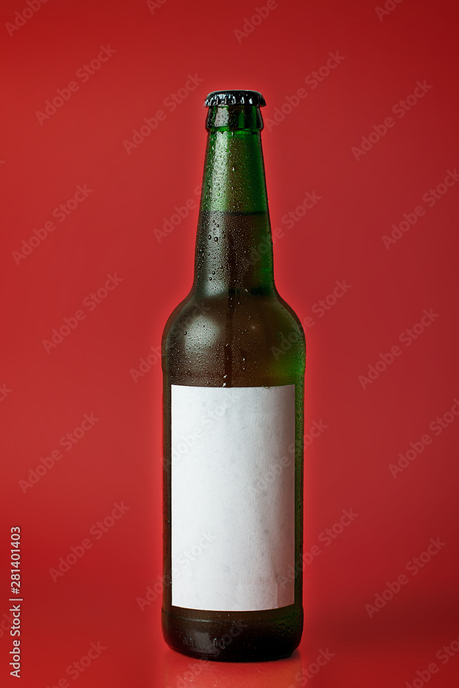 Beer bottle isolated on red background Beer bottle isolated on red background