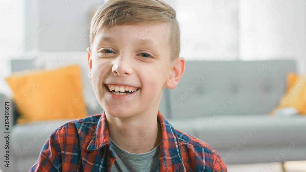 Portrait of Adorable Happy Young Boy Smiling on Camera. In the Background Blurred Sunny Room. Portrait of Adorable Happy Young Boy Smiling on Camera. In the Background Blurred Sunny Room.