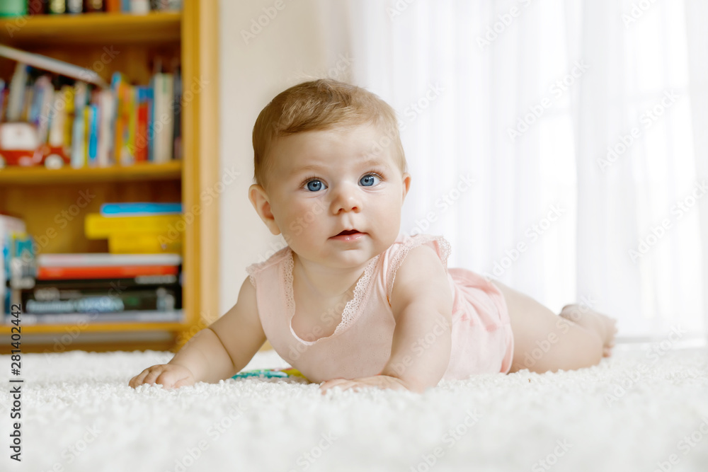 Little funny baby girl lifting body and learning to crawl. Little funny baby girl lifting body and learning to crawl.