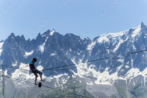 A man walking along a sling against the backdrop of the Alps. Chamonix France.