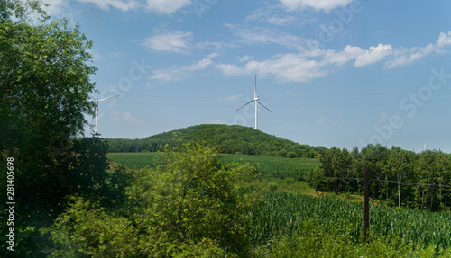 Wind power plants on the hills - green energy.