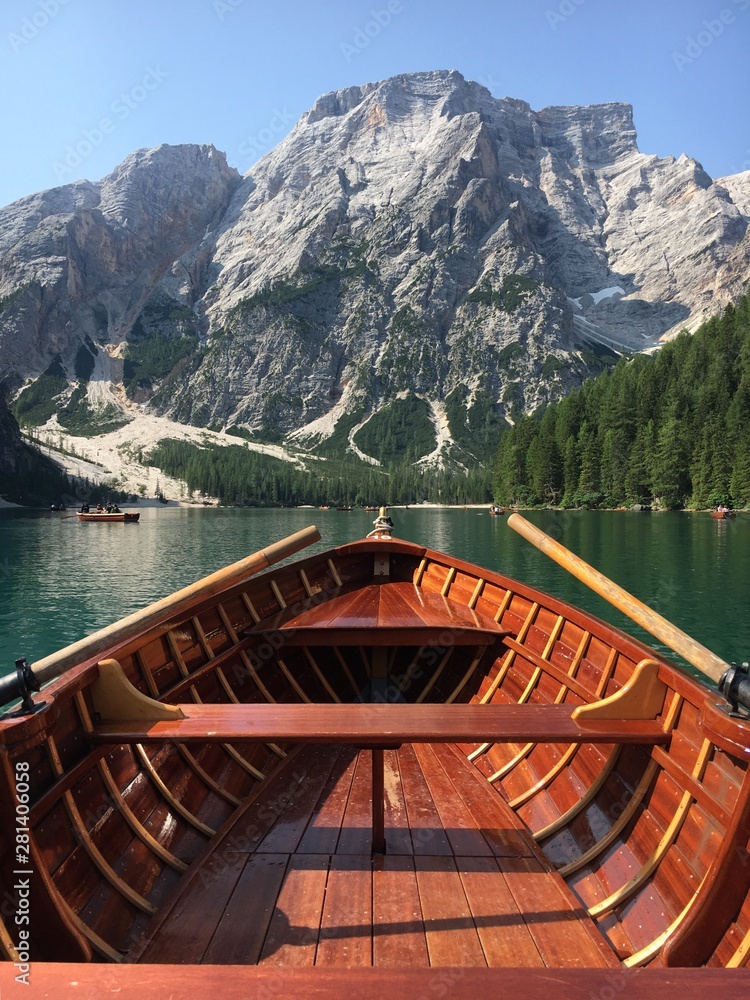 Romantic trip on rowing boat on Braies lake in Dolomites mountains, Sudtirol, Italy.