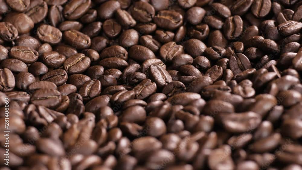 Roasted coffee bean. Fragrant coffee beans scrolls slowly around the camera. Slow Motion Close Up of Whole Roasted Coffee Beans. Roasted coffee bean. Fragrant coffee beans scrolls slowly around the camera. Slow Motion Close Up of Whole Roasted Coffee Beans.