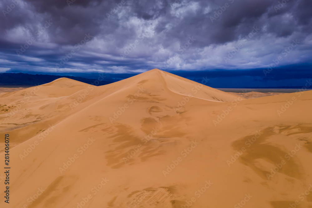 Storm clouds over sand dunes in the desert Storm clouds over sand dunes in the desert