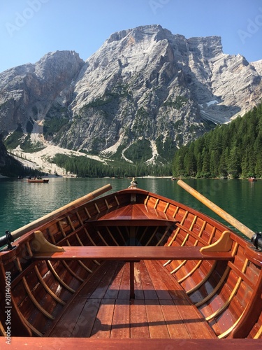 Romantic trip on rowing boat on Braies lake in Dolomites mountains, Sudtirol, Italy.