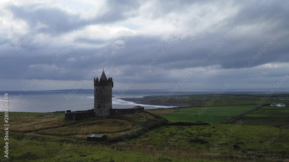 Doonagore Castle fortress, Doolin timelapse fast moving clouds over idyllic medieval monument seascape Doonagore Castle fortress, Doolin timelapse fast moving clouds over idyllic medieval monument seascape