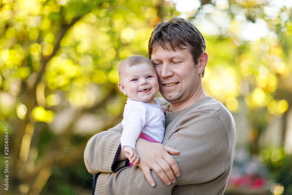 Happy proud young father with newborn baby daughter, family portrait togehter Happy proud young father with newborn baby daughter, family portrait togehter