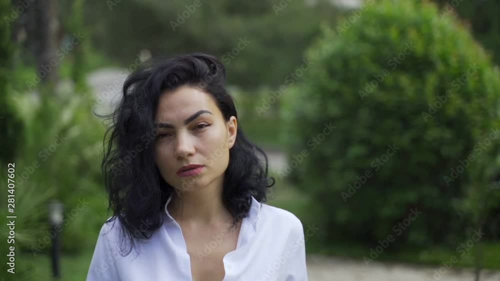 Beautiful Tatar girl in the park walks on the sidewalk Beautiful Tatar girl in the park walks on the sidewalk