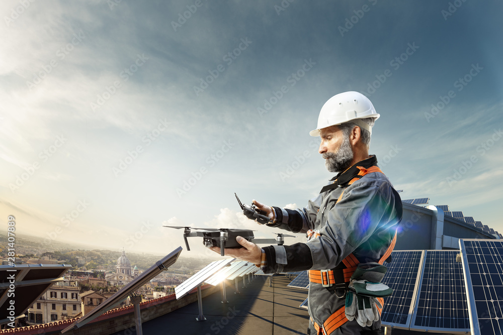 Happy engineer using drone and for cheking solar station. in roof