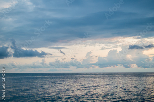 Cloudy and blue sky with calm sea before sunset