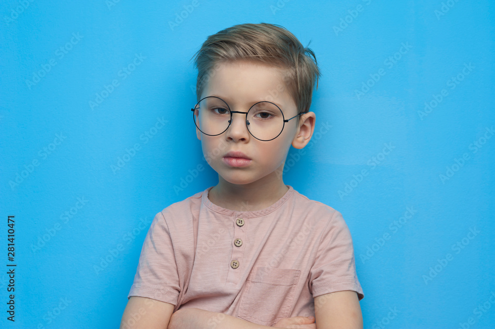 Little cute boy in glasses posing thoughtfully