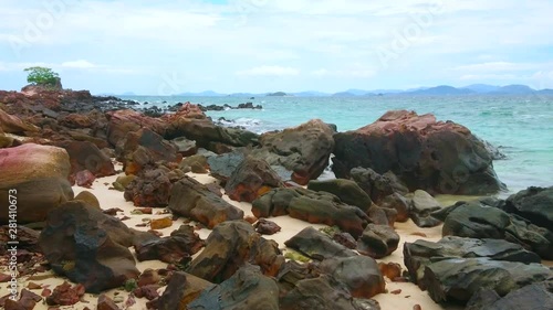 The boulders of distroyed rock formation cover the shoreline of Khai Nai island, Phuket, Thailand photo