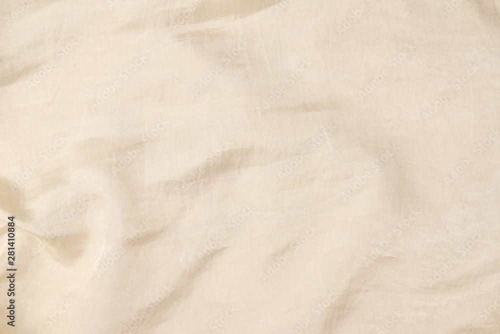 Fototapeta premium Soft smooth beige silk fabric background. Fabric texture.