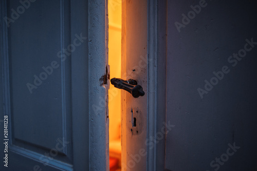 orange light from ajar old door.  intrigue disclosure concept