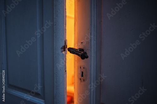 orange light from ajar old door.  intrigue disclosure concept