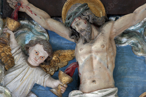 Angel collecting blood from the wounds of Christ, altar adoration of the Magi in the church of the Saint Nicholas in Lijevi Dubrovcak, Croatia photo