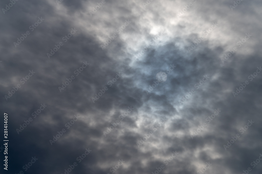 Sky with dark clouds cover the sun
