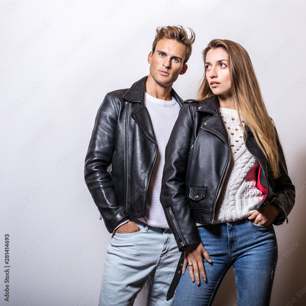 Full Body Picture Of A Fashion Couple Posing On Studio Background While  Looking Down. Stock Photo, Picture and Royalty Free Image. Image 36578192.