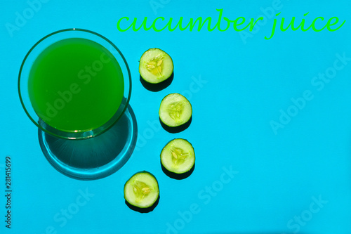  Cucumber juice is isolated on a light blue background. View from the top. Copy space.