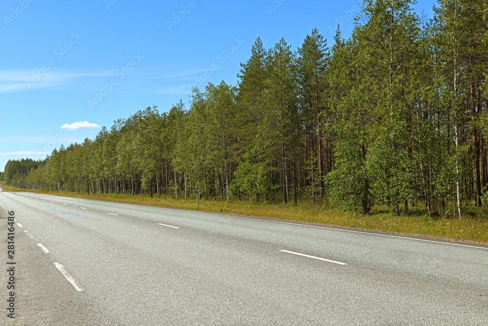 Northern highway in Finnish Lapland. Bright sunny day Northern highway in Finnish Lapland. Bright sunny day