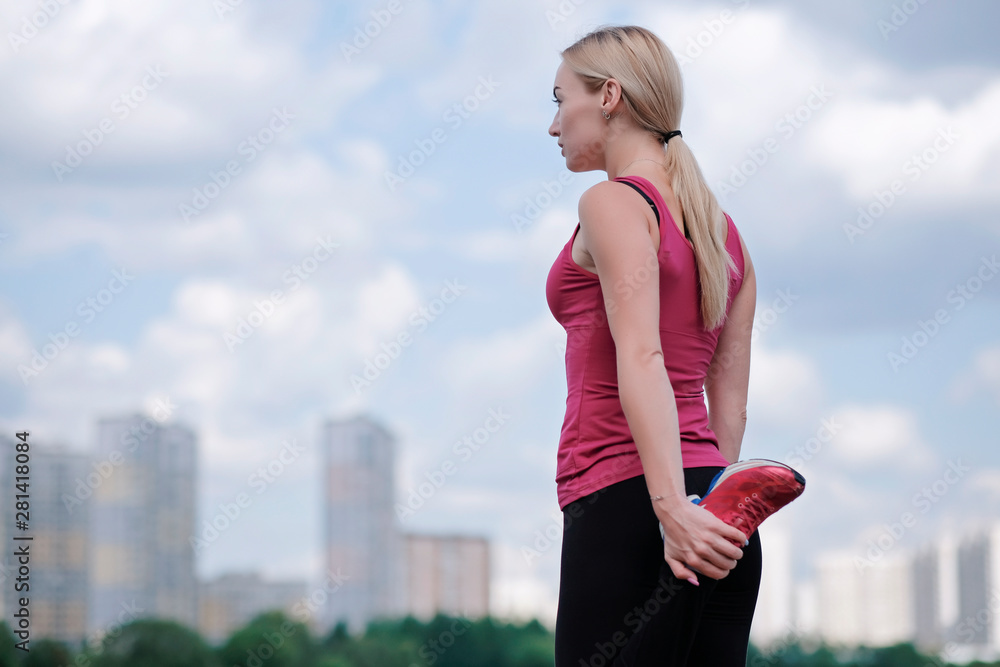 Young sporty woman doing sports outdoors, fitness exercises. Fitness and lifestyle concept