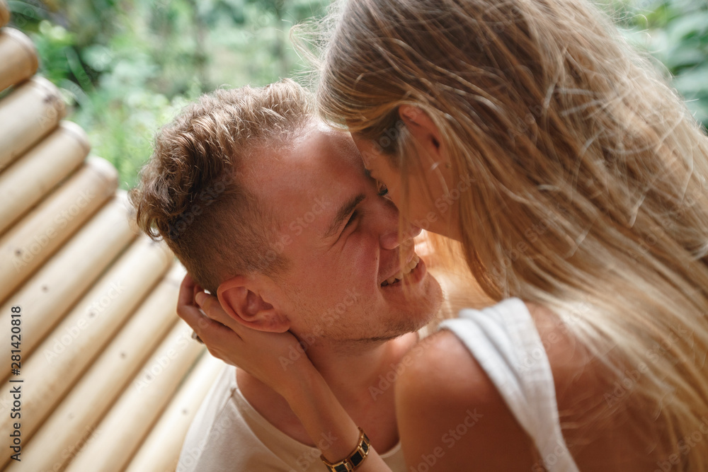 Close up portrait of a beautiful caucasian couple smiling face to face with closed eyes before kissing outside while dating Close up portrait of a beautiful caucasian couple smiling face to face with closed eyes before kissing outside while dating