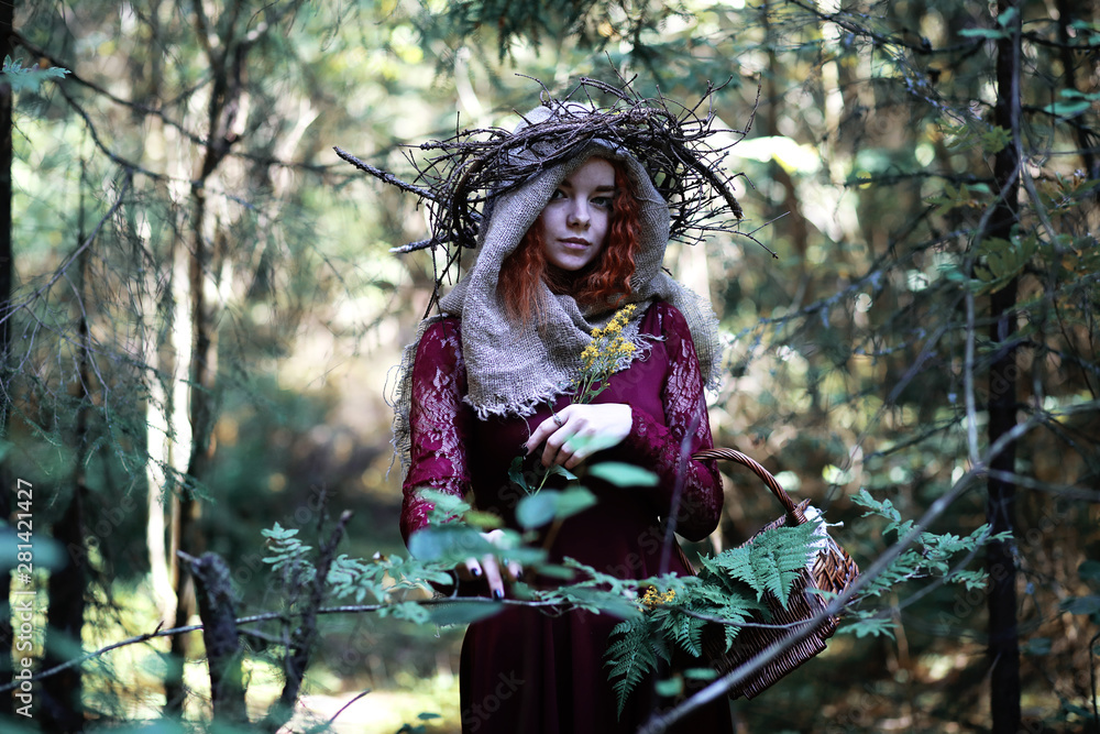 The red-haired witch holds a ritual with a crystal ball The red-haired witch holds a ritual with a crystal ball