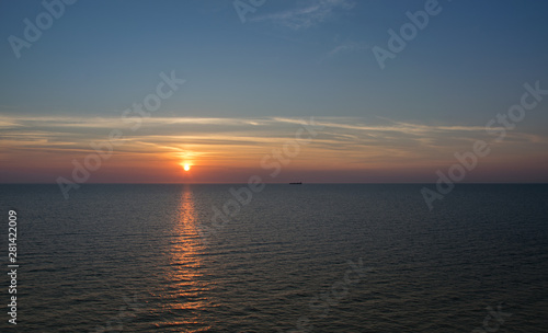 Sunset in the sea on a warm summer evening, seascape. © aleksandra_55