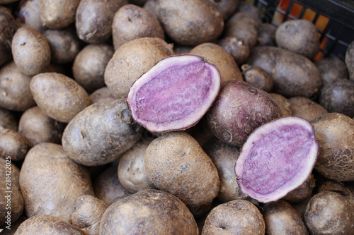 Purple potato. Vitelotte. Purple potatoes. Vegetables background texture. Diet and healthy eating concept. Blue violet potato. Vitelotte potatoes.  photo