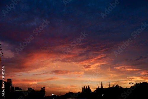 colorful sunset cloud sky above dark city s silhouette