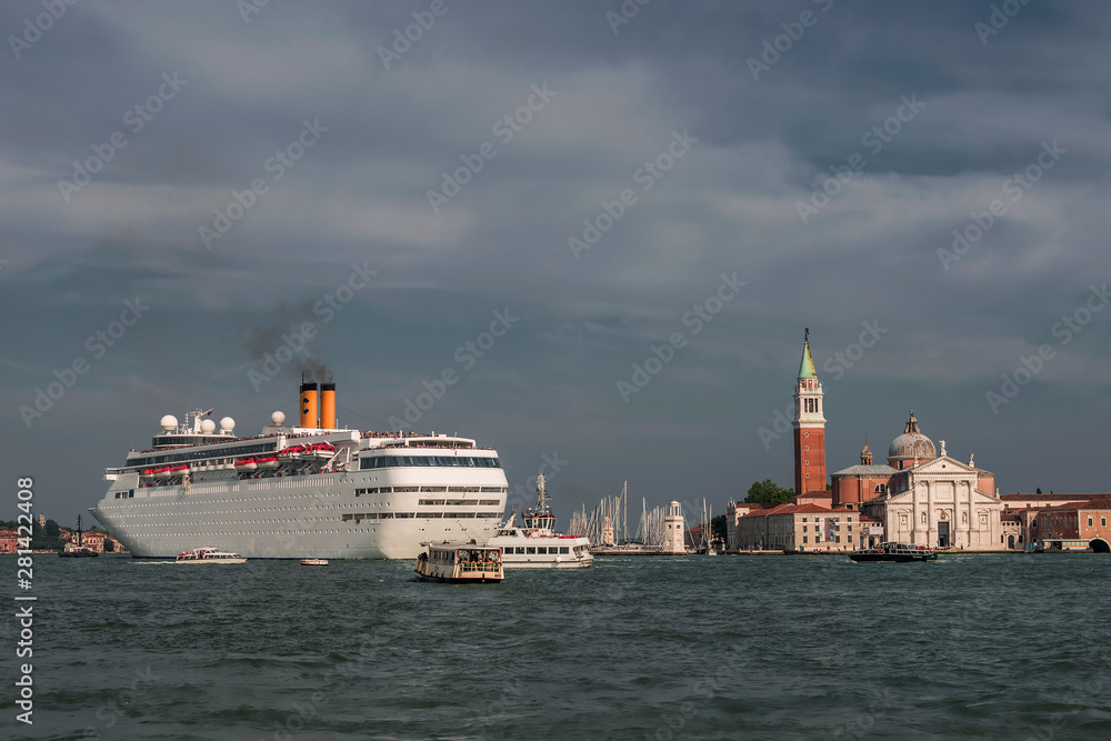 Scenic evening in amazing and budy Venetian Grand Canal with many boats and big cruise ship, Venice, Italy, summer time