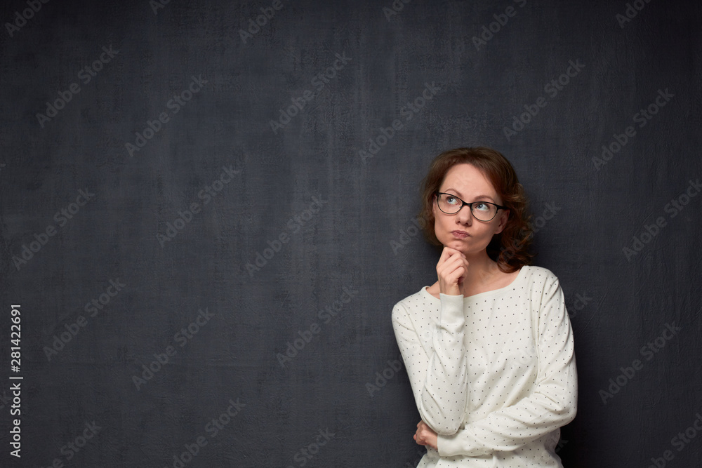 Portrait of thoughtful girl thinking and making up plan Portrait of thoughtful girl thinking and making up plan