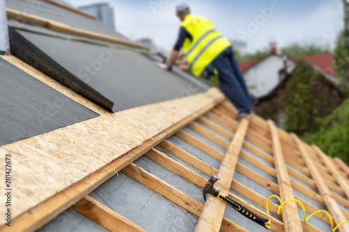 Building construction process of new wooden roof on wood frame house