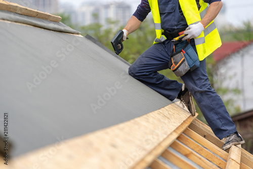Building construction process of new wooden roof on wood frame house