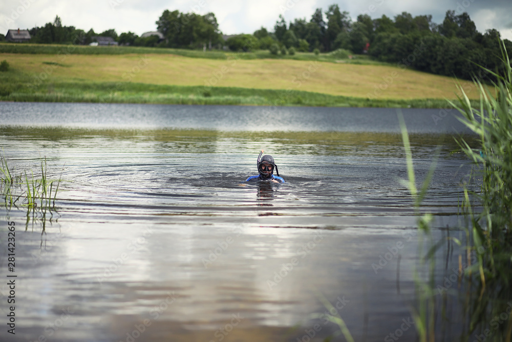 A scuba diver in a wet suit prepares A scuba diver in a wet suit prepares