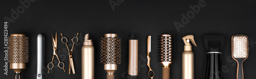 Foto Collection of professional hair dresser tools arranged on dark background