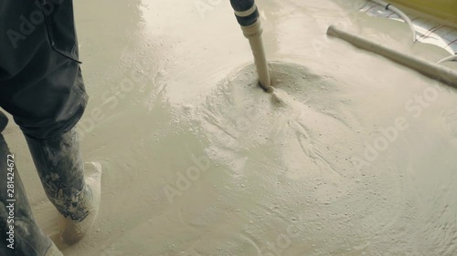 Pouring concrete floor in family house. Anhydrite is optimal binder for production of anhydrite floor screeds. Used as basis for self-leveling poured floors. Construction industry works on building photo