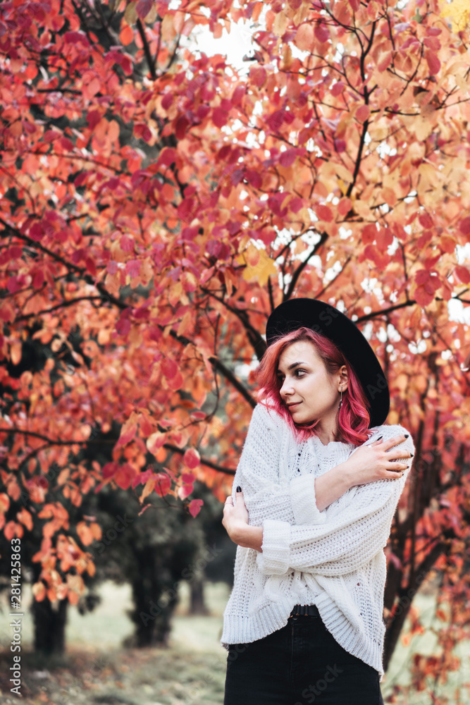 Pretty girl with red hair and hat walking in the park, autumn time. Pretty girl with red hair and hat walking in the park, autumn time.