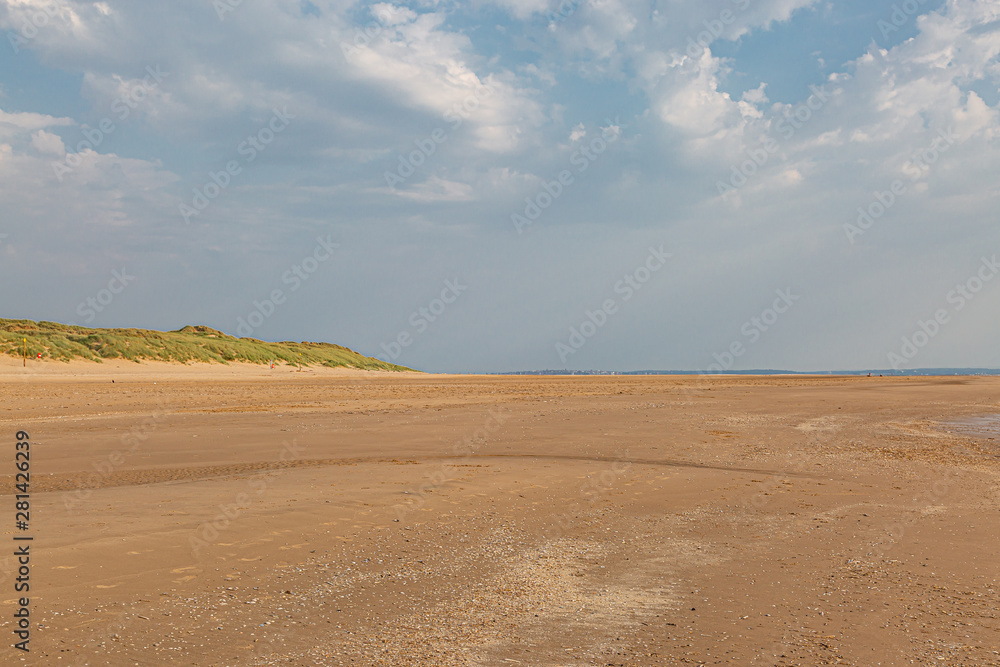 Looking along the vast sandy beach in Formby, Merseyside, on a sunny summers day