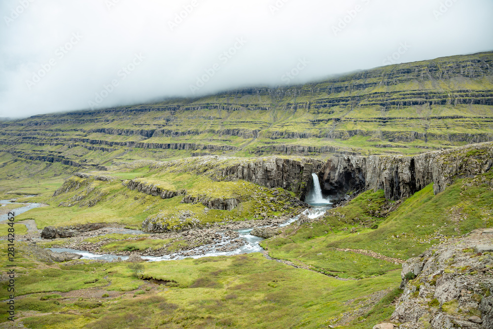 waterfall in a volcanic landscape of Iceland
