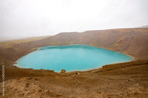 Beautiful view of the turquoise water at Krafla Viti Crater. Volcano  caldera of  Krafla Viti lake. Geothermal valley Leirhnjukur, a tourist attraction of Iceland photo