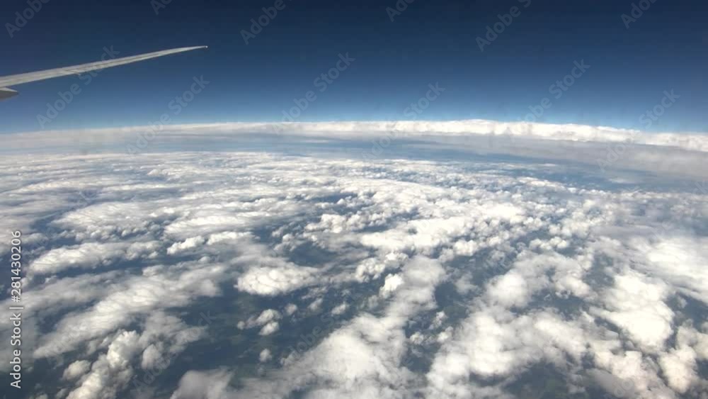 Airplane view flying above fractured clouds Airplane view flying above fractured clouds