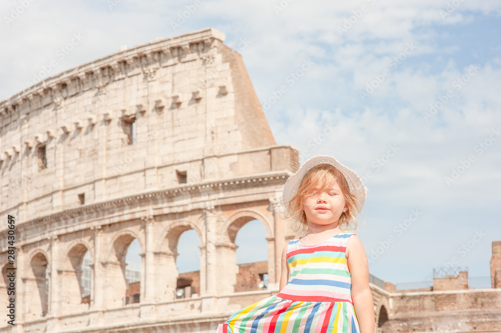 Portrait of a little girl on the background of the Colosseum in Rome, Italy
