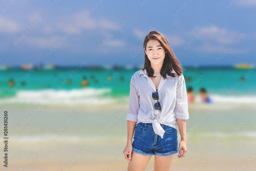 Asian girl enjoying her vacation by the sea Asian girl enjoying her vacation by the sea