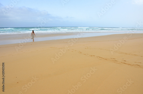 Girl Wearing a Dress Walking by a Long Sand Beach in Fuerteventura, Canary Islands © Jordi