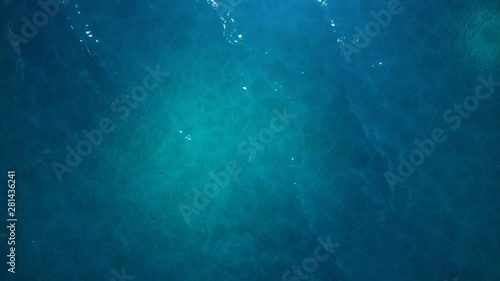 Sea or ocean, waves close-up view. Blue waves sea water. Blue crystal clear water. One can see the sandy seabed. Sea waves top view. 3D 4K animation