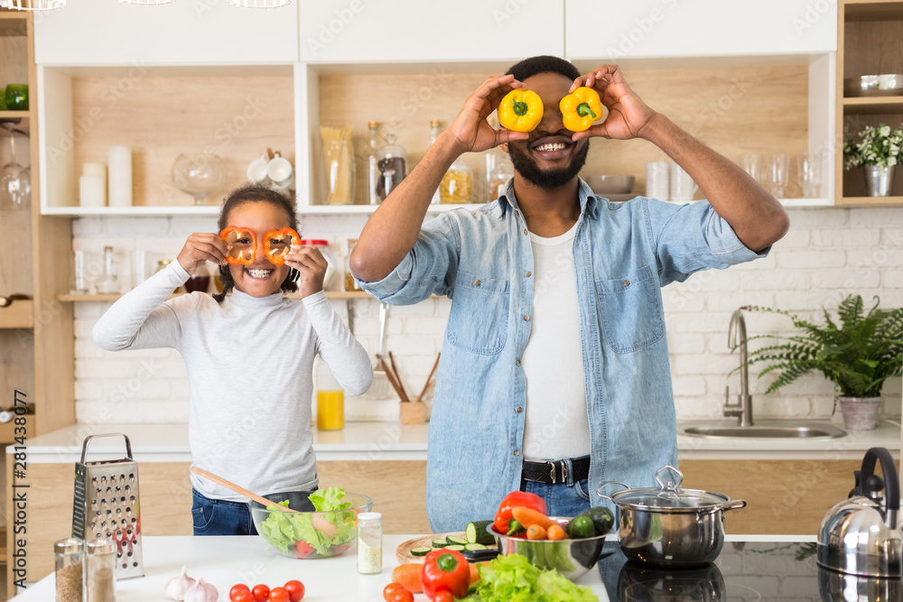 Playful father and daughter having fun in kitchen Playful father and daughter having fun in kitchen